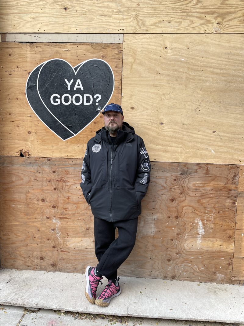David Gensler Japan outdoor culture portrait in outdoor apparel beside Ya Good street art